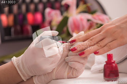Image of Woman hands receiving a manicure