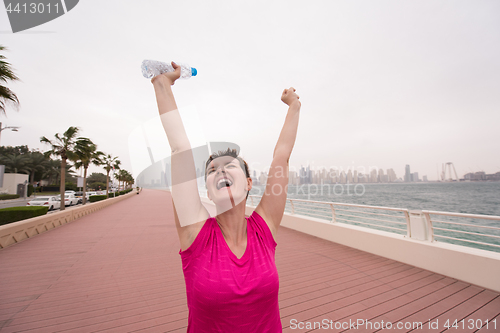 Image of young woman celebrating a successful training run