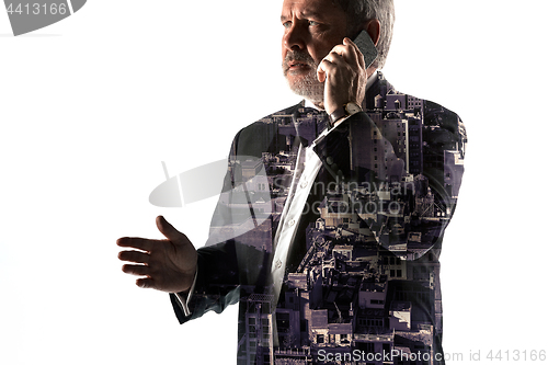 Image of Portrait of bearded businessman with phone. Double exposure city on the background.