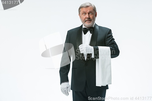 Image of Senior waiter holding white towel