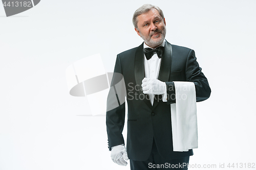 Image of Senior waiter holding white towel