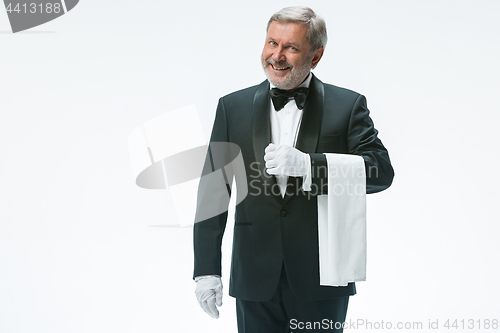 Image of Senior waiter holding white towel