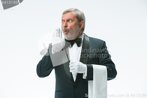 Image of Senior waiter holding white towel