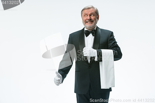 Image of Senior waiter holding white towel