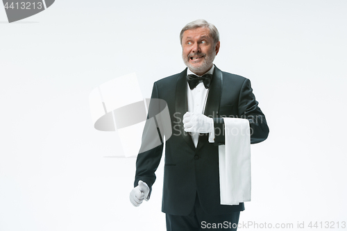 Image of Senior waiter holding white towel