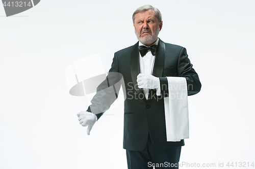 Image of Senior waiter holding white towel