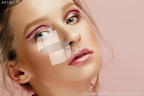 Image of Beauty face of young fashion model woman with bright eyes and lips