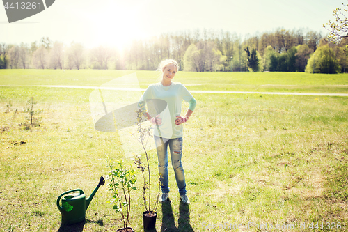 Image of happy young volunteer woman outdoors