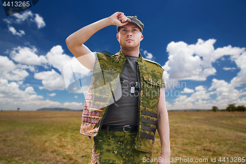 Image of soldier in military uniform over sky background