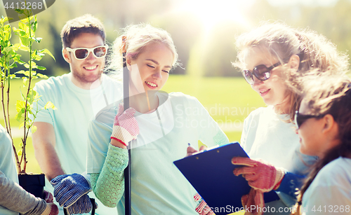 Image of group of volunteers planting trees in park