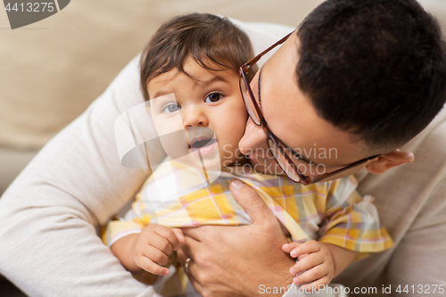 Image of happy father with little baby daughter at home