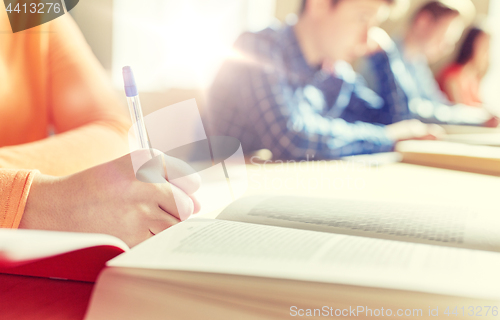 Image of close up of students with book writing school test