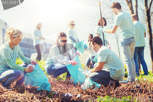 Image of volunteers with garbage bags cleaning park area