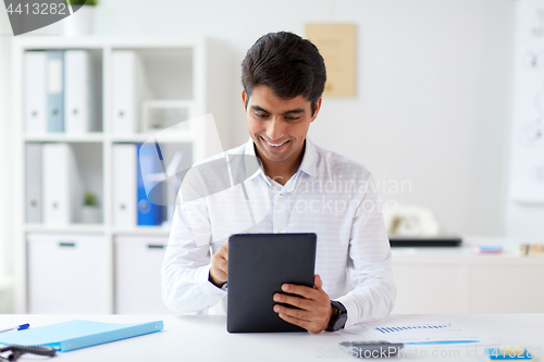 Image of businessman working with tablet pc at office