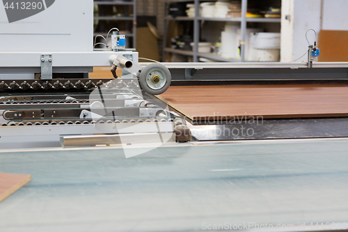 Image of chipboards on conveyer at furniture factory