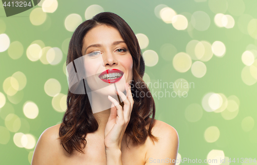 Image of beautiful smiling young woman with red lipstick