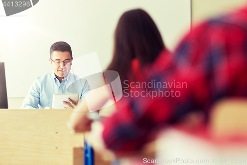 Image of students and teacher with tablet pc at school