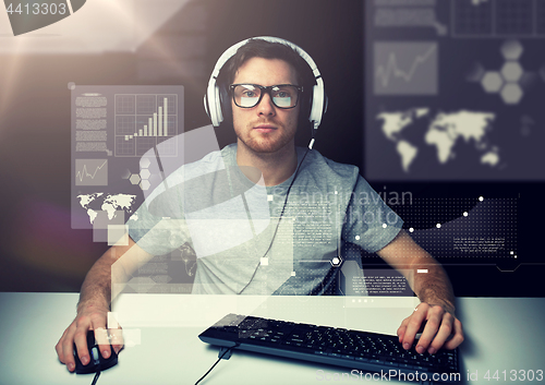 Image of man in headset with computer over virtual screens