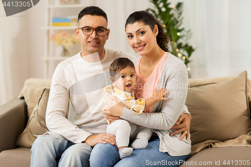 Image of happy family with baby daughter at home