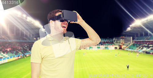 Image of man in virtual reality headset over football field