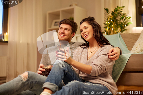 Image of happy couple drinking coffee and eating at home