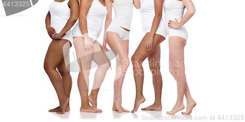 Image of group of happy diverse women in white underwear