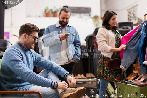 Image of friends choosing clothes at vintage clothing store