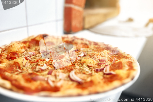 Image of baked pizza at pizzeria