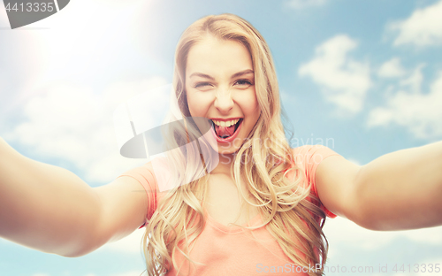 Image of happy smiling young woman taking selfie