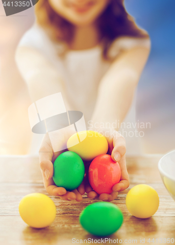 Image of close up of girl holding colored easter eggs