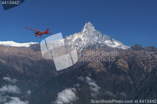 Image of Ultralight plane flies over Pokhara and Machapuchare