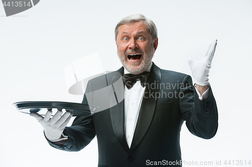 Image of Senior waiter holding tray