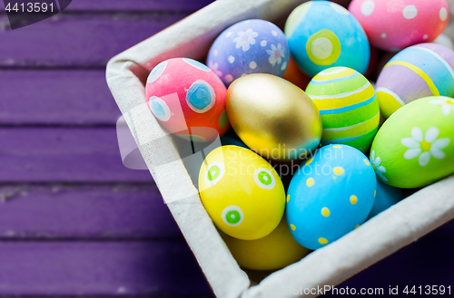 Image of close up of colored easter eggs in basket