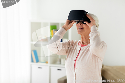 Image of old woman in virtual reality headset or 3d glasses