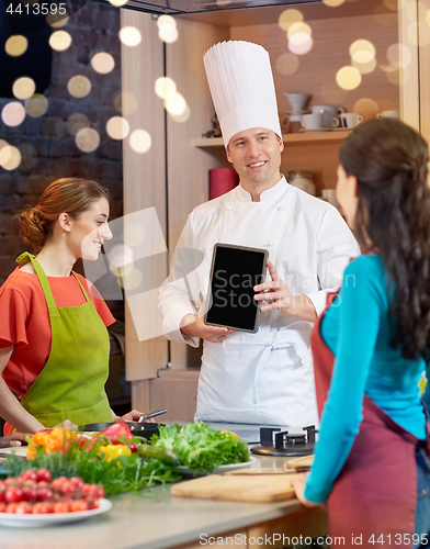 Image of happy women with chef and tablet pc in kitchen