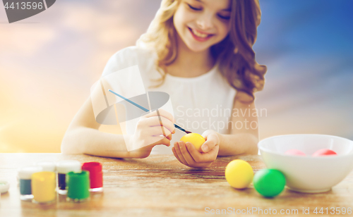 Image of close up of girl coloring easter eggs