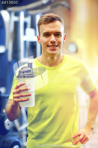 Image of smiling man with protein shake bottle