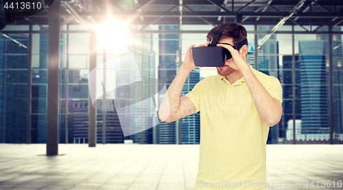 Image of happy man in virtual reality headset or 3d glasses