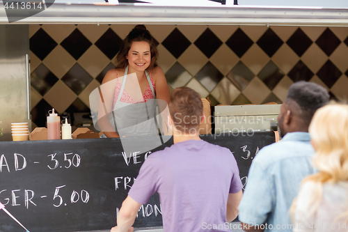 Image of queue of customers and saleswoman at food truck