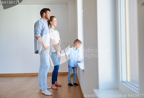 Image of happy family with child at new home or apartment
