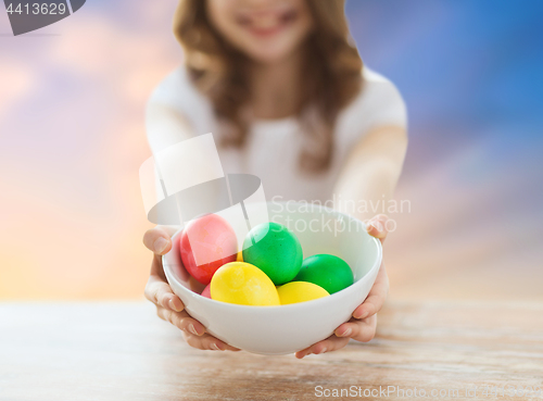 Image of close up of girl holding colored easter eggs