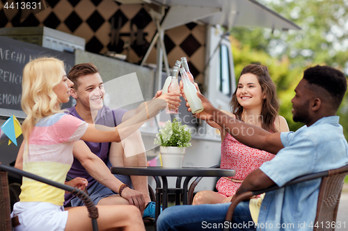 Image of friends clinking bottles with drinks at food truck