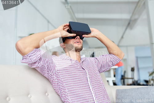 Image of happy man with virtual reality headset at office