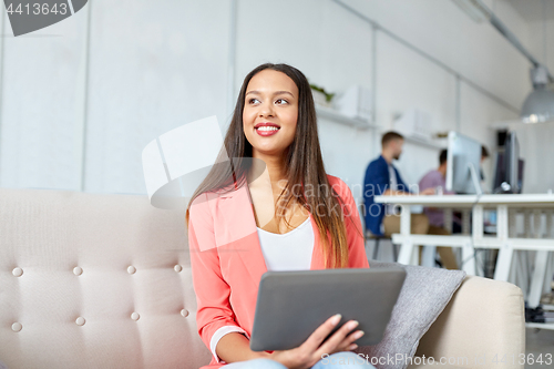 Image of happy asian woman with tablet pc working at office