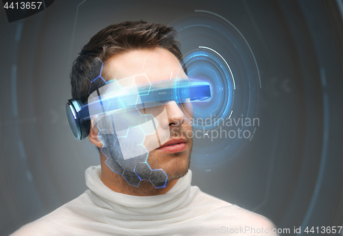 Image of man in 3d glasses with virtual hologram