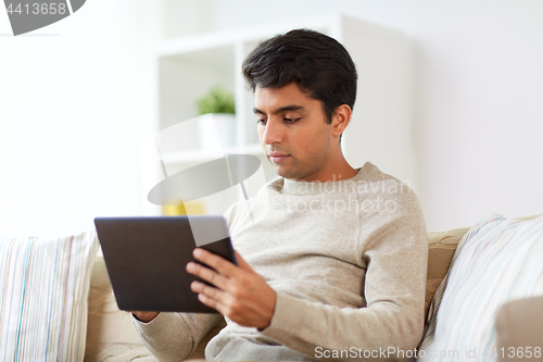 Image of man with tablet pc at home