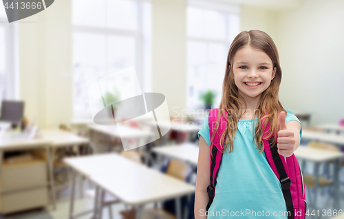 Image of smiling girl with school bag showing thumbs up