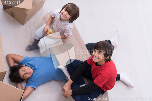 Image of boys with cardboard boxes around them top view