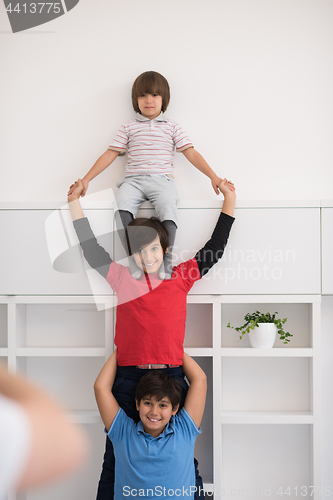 Image of young boys posing line up piggyback