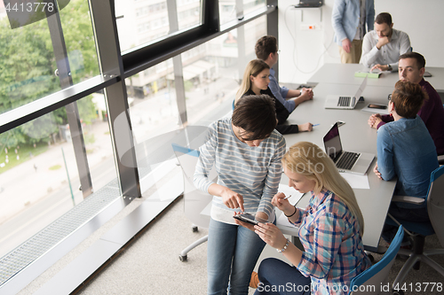 Image of Pretty Businesswomen Using Tablet In Office Building during conf